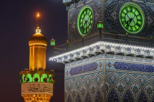 مناره ساعت و گلدسته همراه با بنر ولادت امام علی علیه‌السلام