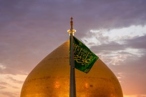 گنبد حرم امیرالمؤمنین و پرچم سبز روبروی آن