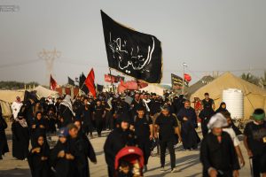 زائران اربعین پای پیاده در جاده حرکت می‌کنند