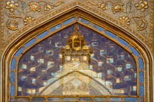 مناره ساعت حرم علوی در قاب یک طاق تزئینی