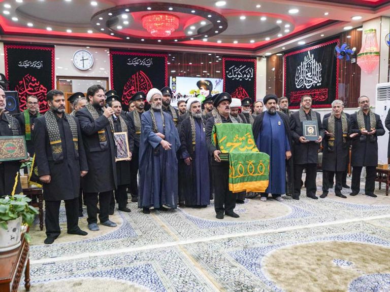 خادمان حرم مطهر رضوی در حال تحویل پرچم به هیئت‌امنای آستان مقدس علوی